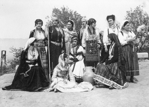 Group portrait of women in traditional attire, Delphic Celebrations 1930. Photo by Nelly's. Top row, third from left, Mrs. Virginia Romanos, née Benaki, and bottom row, second seated from left, Ms. Argiro Paparrigopoulou. Alexandros Romanos Archive.